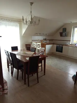 a dining room and kitchen with a table and chairs at Rainbow Hill in Giebułtów