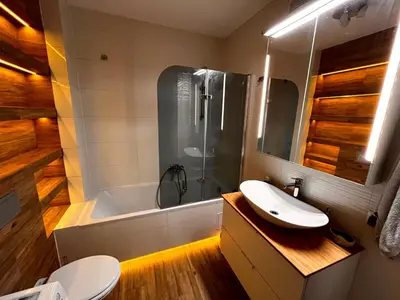 a bathroom with a sink and a tub and a toilet at Blue Apartment KRK with Balcony in Kraków
