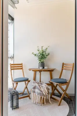 a room with two chairs and a table with a potted plant at Tauron Arena - Parking, Balcony, AirCon - by Rentujemy in Kraków