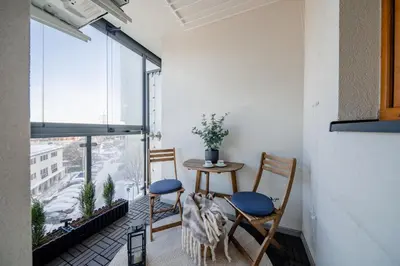 a room with two chairs and a table and a window at Tauron Arena - Parking, Balcony, AirCon - by Rentujemy in Kraków