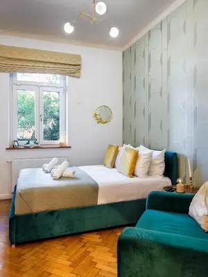 a bedroom with a large bed and a couch at Quiet Courtyard Studio by Tyzenhauz in Kraków