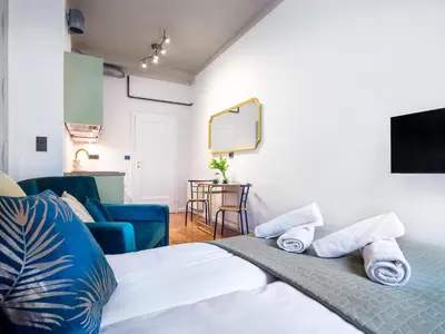 a bedroom with a bed and a living room at Quiet Courtyard Studio by Tyzenhauz in Kraków