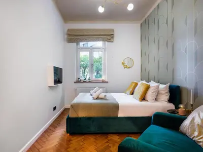 a bedroom with a bed and a couch at Quiet Courtyard Studio by Tyzenhauz in Kraków