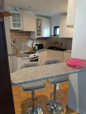 a kitchen with a granite counter top and bar stools at Paula Apart in Wadowice