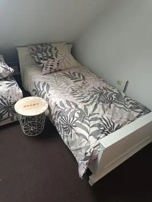 a bedroom with a bed and a small table at Paula Apart in Wadowice