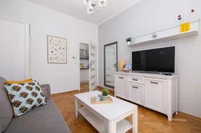 a living room with a couch and a flat screen tv at Unique Rzeszowska Apartment in Kazimierz by Noclegi Renters in Kraków