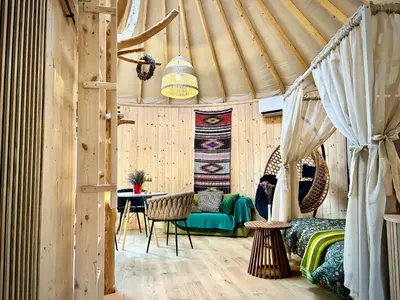 a room with a tent with a bed and a table at Jurta Jura leśna in Przybysławice