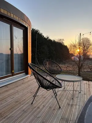 two benches sitting on top of a wooden deck at Jurta Jura leśna in Przybysławice