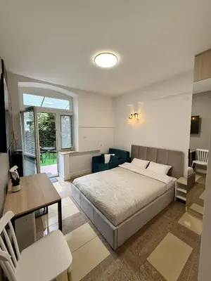 a bedroom with a bed and a table and chairs at Modern studio Old Town Railway Station in Kraków