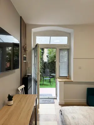 a room with a dining table and a door to a patio at Modern studio Old Town Railway Station in Kraków