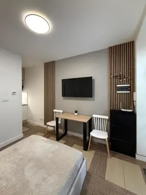 a hotel room with a desk and a tv at Modern studio Old Town Railway Station in Kraków
