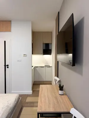 a small apartment with a dining table and a kitchen at Modern studio Old Town Railway Station in Kraków