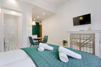 a bedroom with a large bed with two pillows at Green & Gold Studio near Vistula by Tyzenhauz in Kraków