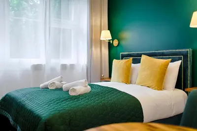a green bedroom with a bed with towels on it at Green & Gold Studio near Vistula by Tyzenhauz in Kraków