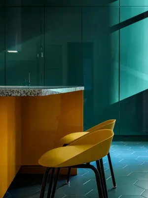 a yellow chair sitting next to a counter at Royal Vistula Luxury Apartment in Kraków