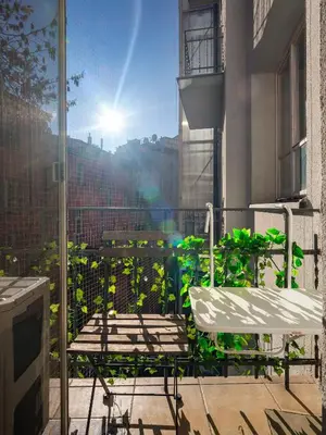a patio with a table and a chair on a balcony at Royal Vistula Luxury Apartment in Kraków
