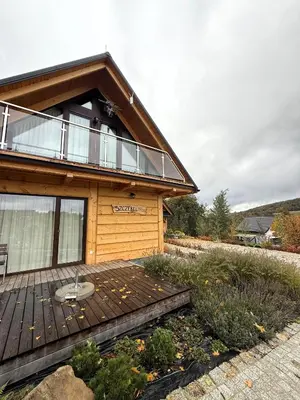 a wooden deck in front of a house at Apartament w górach SZCZEBEL in Tenczyn