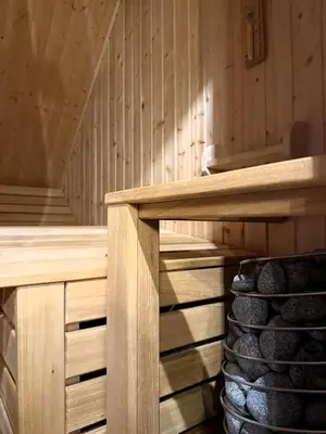a wooden sauna with a stack of logs at Apartament w górach SZCZEBEL in Tenczyn
