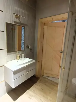 a bathroom with a white sink and a mirror at Apartament w górach SZCZEBEL in Tenczyn