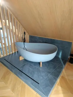 a bath tub sitting on a counter in a bathroom at Apartament w górach SZCZEBEL in Tenczyn