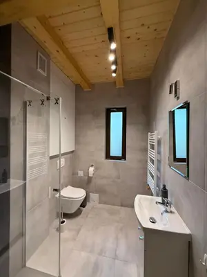 a bathroom with a toilet and a sink and a shower at Apartament w górach SZCZEBEL in Tenczyn