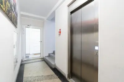 a hallway with a metal door in a building at Bosacka Downtown Apartment by BookingHost in Kraków