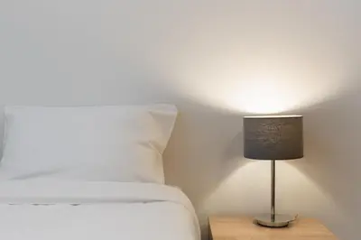 a bedroom with a bed and a lamp on a table at Bosacka Downtown Apartment by BookingHost in Kraków