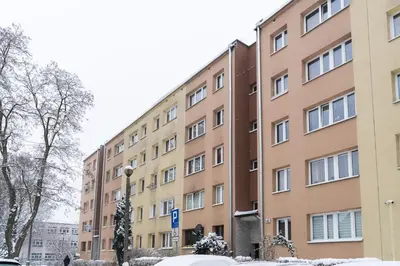 an apartment building in the snow at Jaremy Standard Apartment by BookingHost in Kraków