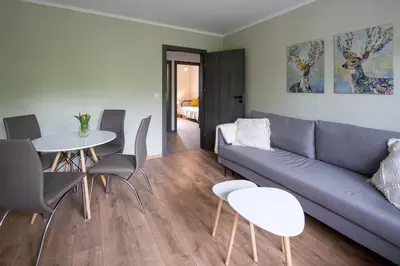 a living room with a couch and a table and chairs at Spacious oasis in the center in Kraków
