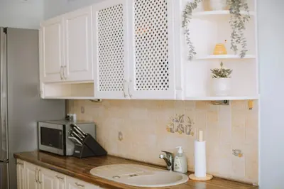 a kitchen counter with a sink and a microwave at Kraków Modern Apartment | 6 Guests, Parking/Tram in Kraków