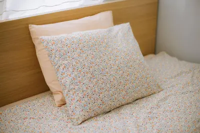 a pillow sitting on top of a bed at Kraków Modern Apartment | 6 Guests, Parking/Tram in Kraków