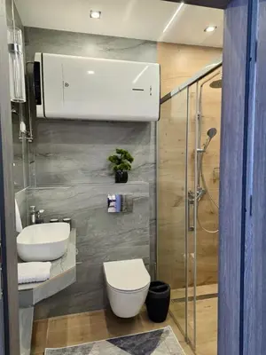 a bathroom with a toilet and a sink at Domki Leśne Zacisze in Baczyn