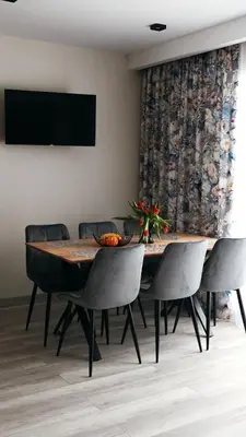 a dining room with a table and chairs at Domki Leśne Zacisze in Baczyn
