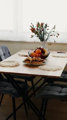 a wooden table with a bowl of fruit on it at Domki Leśne Zacisze in Baczyn