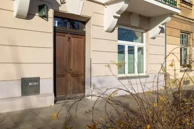 a house with a wooden door and a window at Atmospheric Apartment Close to the Vistula Boulevards by Noclegi Renters in Kraków