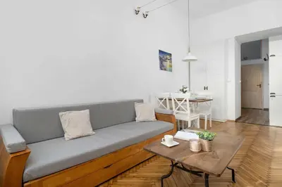 a living room with a couch and a table at Atmospheric Apartment Close to the Vistula Boulevards by Noclegi Renters in Kraków