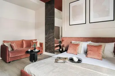 a bedroom with a bed and a couch at The Garden Collection in Kraków