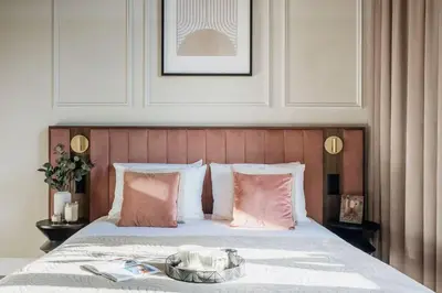a bedroom with a bed with a tray on it at The Garden Collection in Kraków