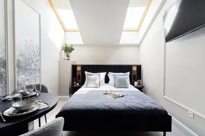 a bedroom with a bed and a table with a bowl on it at The Garden Collection in Kraków