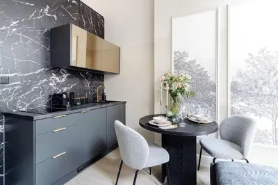 a kitchen with a table and chairs and a counter at The Garden Collection in Kraków