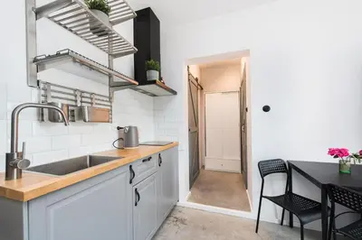 a kitchen with a sink and a table with chairs at MAWKA near Enerdgylandia in Zator