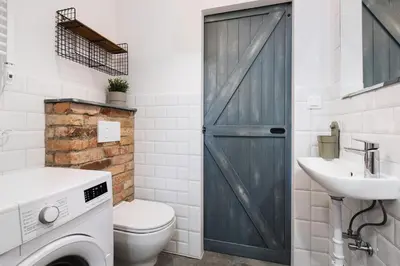 a bathroom with a toilet and a sink and a door at MAWKA near Enerdgylandia in Zator