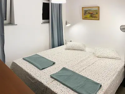 a bedroom with a bed with two green napkins on it at MAWKA near Enerdgylandia in Zator