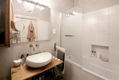 a white bathroom with a sink and a shower at MAGICAL apartment in Kraków