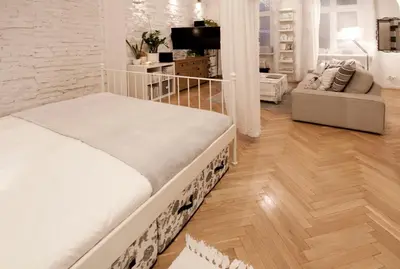 a white bedroom with a bed and a living room at MAGICAL apartment in Kraków