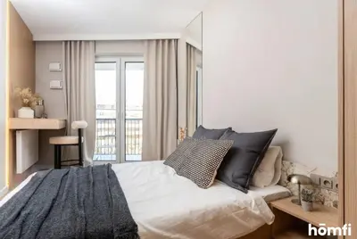 a bedroom with a large bed and a window at Winewood Apartment - homfi Collection in Kraków
