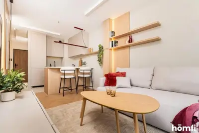 a living room with a white couch and a table at Winewood Apartment - homfi Collection in Kraków