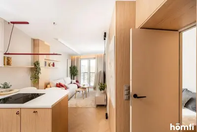 a kitchen and living room with a couch and a table at Winewood Apartment - homfi Collection in Kraków