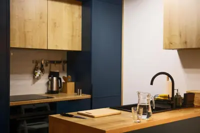 a kitchen with a counter top with a sink and a sink at Krzemień Apartment in Oświęcim