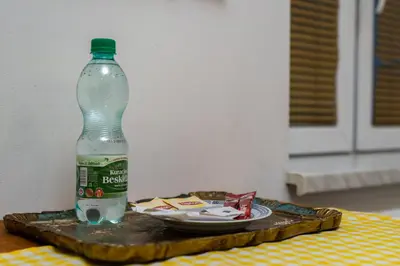 a bottle of water sitting on top of a tray at Bonarka Homely Studio by BookingHost in Kraków